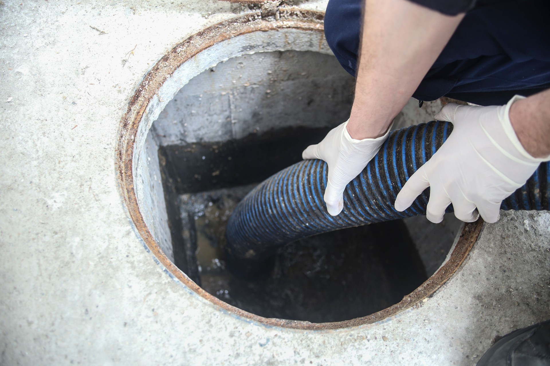 Worker cleaning the sewage system